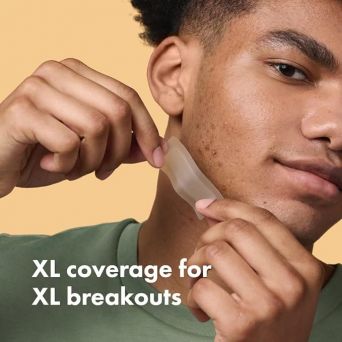 Man applying hero mighty patch surface xl on the jawline, demonstrating large acne patches for face breakouts.